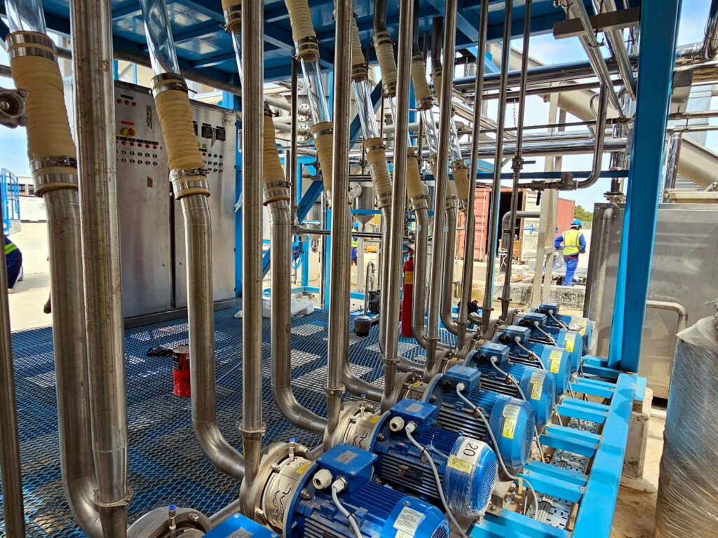 Stainless steel process piping and pump assembly engineered by FPM GLOBAL.