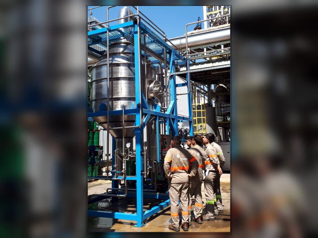 Industrial commissioning team inspecting an FPM GLOBAL distillation system.