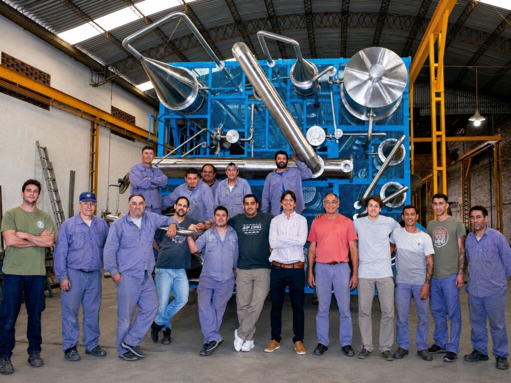 FPM GLOBAL engineering and fabrication team in front of a custom stainless steel process equipment module.